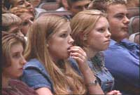 Students watching school assembly about smoking.