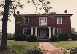 R.J. Reynolds' childhood home stands a modest brick two story home.